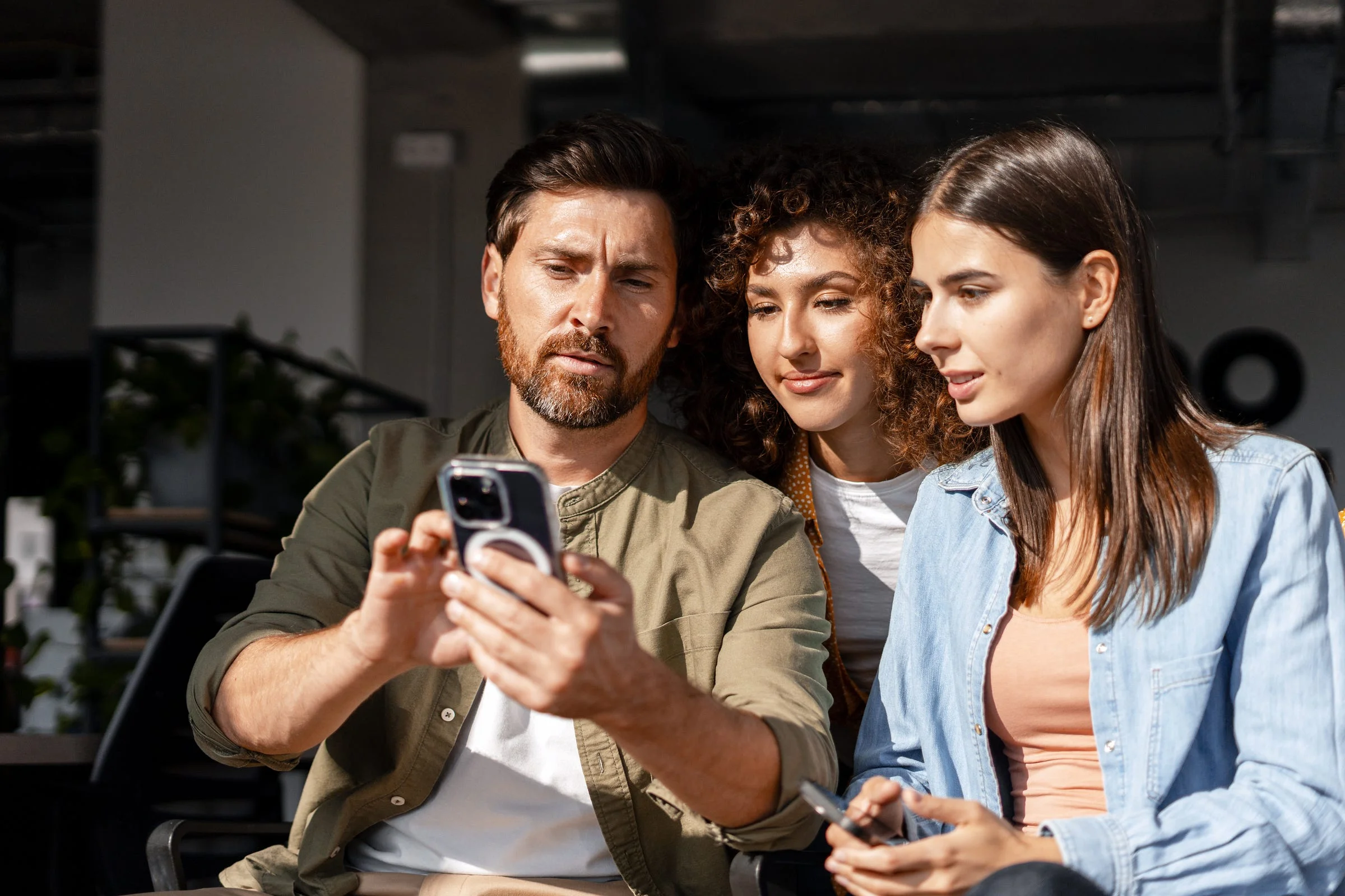 Diners on smartphones researching restaurants and watching food videos before visiting